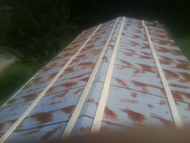 Rusted metal roof panels with new wood purlins before replacement — Storm Damage Roof Repair in Bushnell by Roofing Brothers